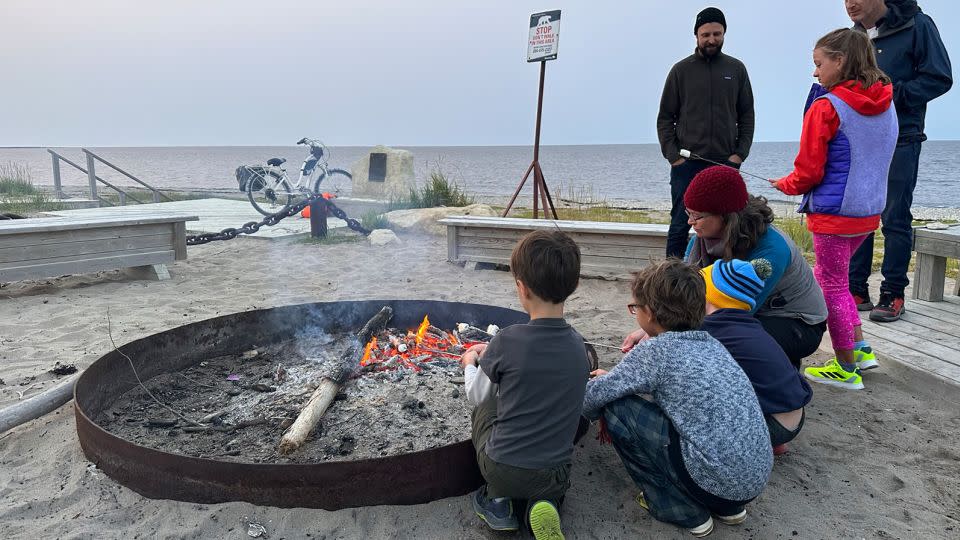 With a polar bear guard scouting the perimeter, Frontiers North Adventure guests roast s’mores at a bonfire on Churchill’s city beach. - Terry Ward