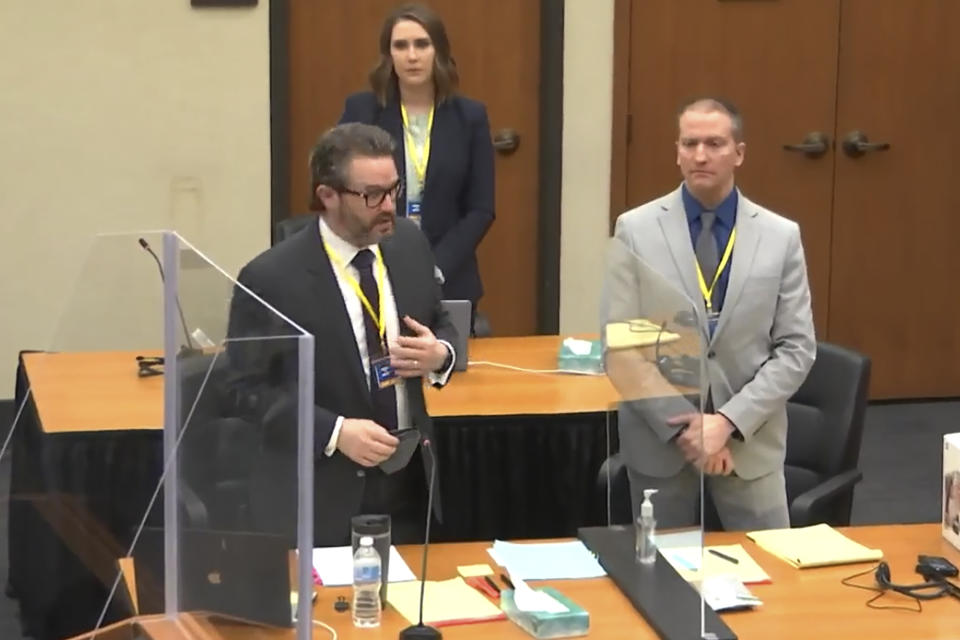 In this screen grab from video, defense attorney Eric Nelson, left, defendant and former Minneapolis police officer Derek Chauvin, right, and Nelson's assistant Amy Voss, back, introduce themselves to jurors as Hennepin County Judge Peter Cahill presides over jury selection in the trial of Chauvin Wednesday, March 17, 2021 at the Hennepin County Courthouse in Minneapolis, Minn. Chauvin is charged in the May 25, 2020 death of George Floyd. (Court TV, via AP, Pool)