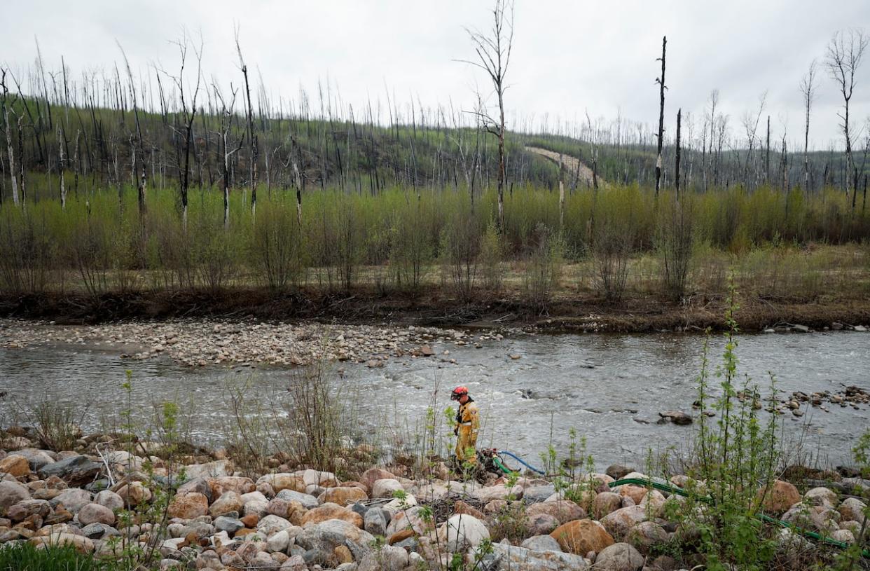 A wildfire that forced thousands of people to evacuate several Fort McMurray neighbourhoods earlier this month is now classified as being held. (Jeff McIntosh/The Canadian Press - image credit)