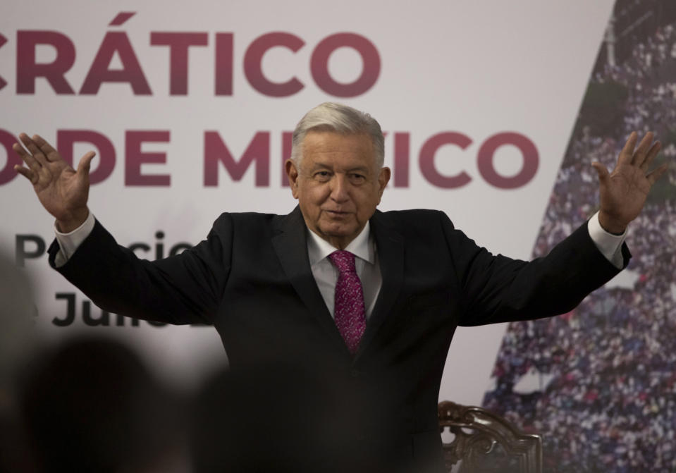 FILE - In this July 1, 2021 file photo, Mexican President Andres Manuel Lopez Obrador waves after giving a speech at a ceremony marking the third anniversary of his presidential election at the National Palace in Mexico City. Mexico's anti-monopoly regulator has on Wednesday, July 28, 2021, openly criticized President Lopez Obrador's plan to set a maximum price for cooking and heating gas. (AP Photo/Fernando Llano, File)