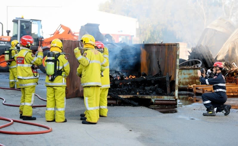 firefighters at the bin where factory fire in welshpool began.