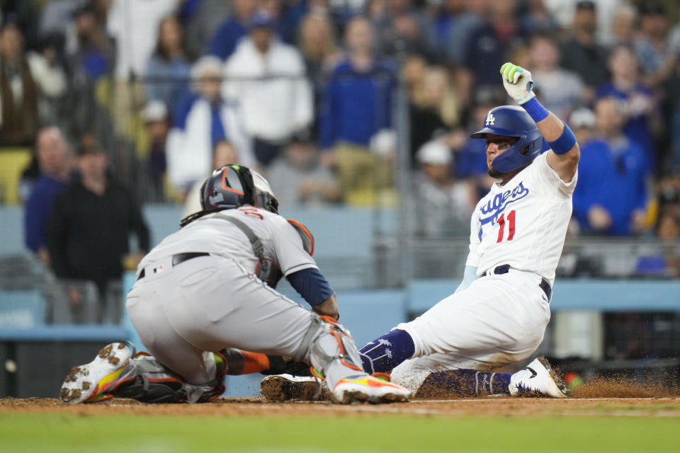 Los Angeles Dodgers' Miguel Rojas (11) is tagged out by Houston Astros catcher Martin Maldonado during the fourth inning of a baseball game Friday, June 23, 2023, in Los Angeles. (AP Photo/Jae C. Hong)