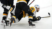 Pittsburgh Penguins' Jason Zucker (16) is dropped to the ice against the Boston Bruins during the second period of an NHL hockey game, Tuesday, Jan. 26, 2021, in Boston. (AP Photo/Charles Krupa)