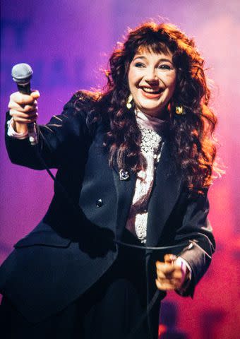 Dave Hogan/Getty Kate Bush onstage with a microphone