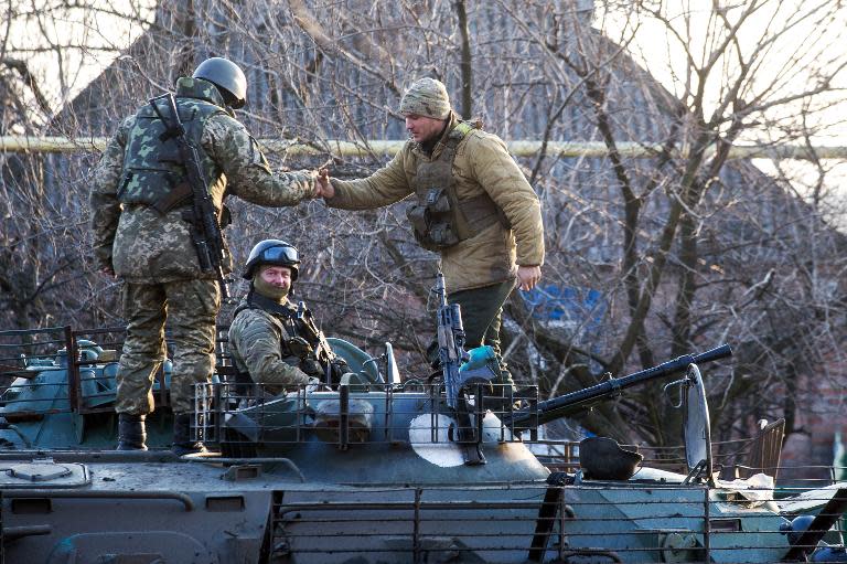 Ukrainian servicemen shake hands in the village of Horlivka, Donetsk region, on February 4, 2015