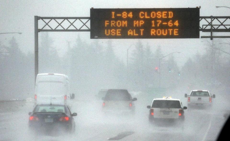 A traffic sign alerts drivers on Interstate 84 in Troutdale, Ore., of road closures, Wednesday, Jan. 18, 2017. An ice storm shut down parts of major highways and interstates Wednesday in Oregon and Washington state and paralyzed the hardest hit towns along the Columbia River Gorge with up to 2 inches of ice coating the ground in some places.(AP Photo/Don Ryan)