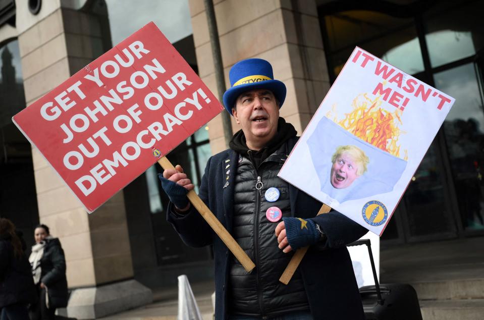 Political activist Steve Bray holds ‘partygate’ and anti-Boris Johnson placards outside Portcullis House opposite Parliament (AFP/Getty)