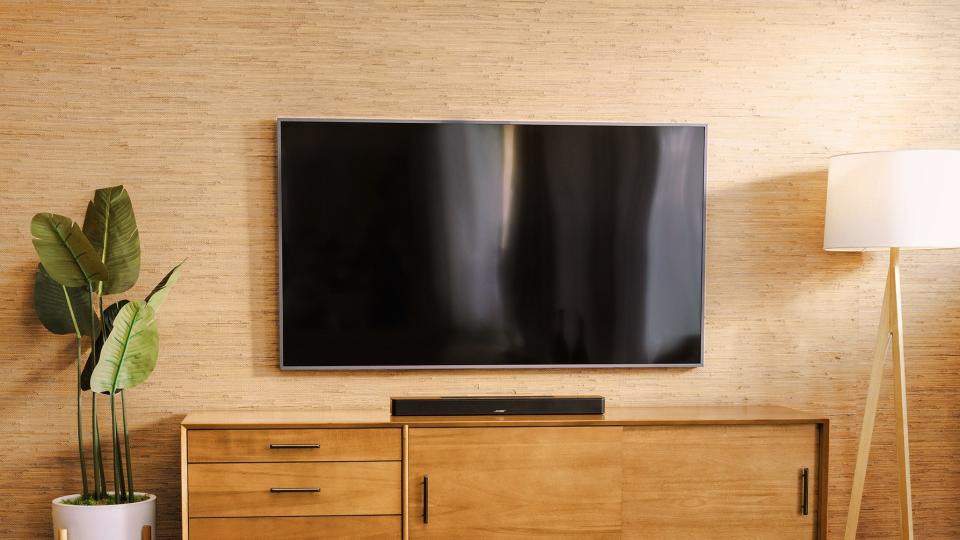 Bose Soundbar 600 on table under TV in living room setting