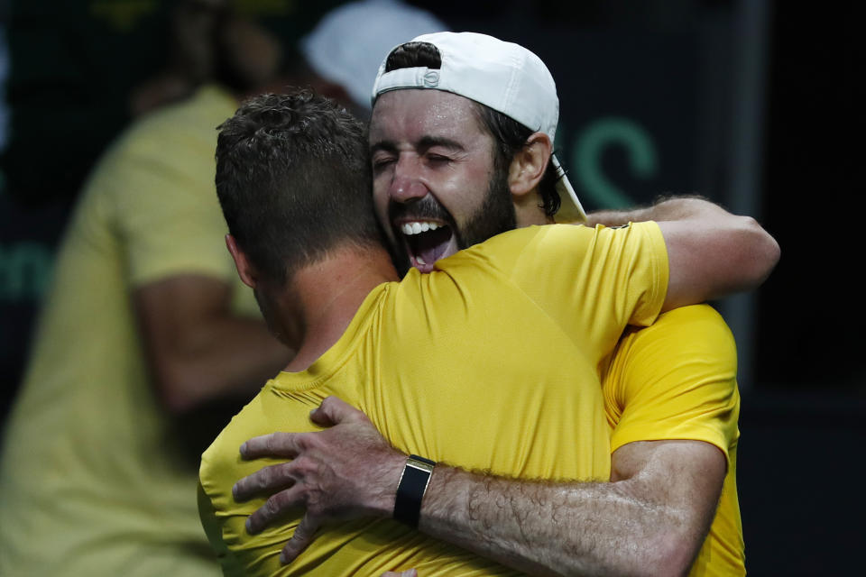 Australia's Jordan Thompson, right, celebrates with team Captain Lleyton Hewitt after defeating Netherland's Tallon Griekspoor during a Davis Cup quarter-final tennis match between Australia and The Netherlands in Malaga, Spain, Tuesday, Nov. 22, 2022. (AP Photo/Joan Monfort)