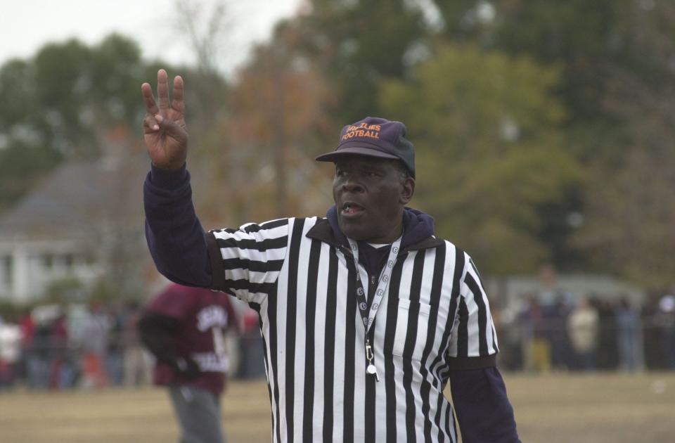 William Murphy referees the Turkey Bowl in 2003. He was 65 years old at the time and had last played in the game 30 years before and had been refereeing it since the 1970s.