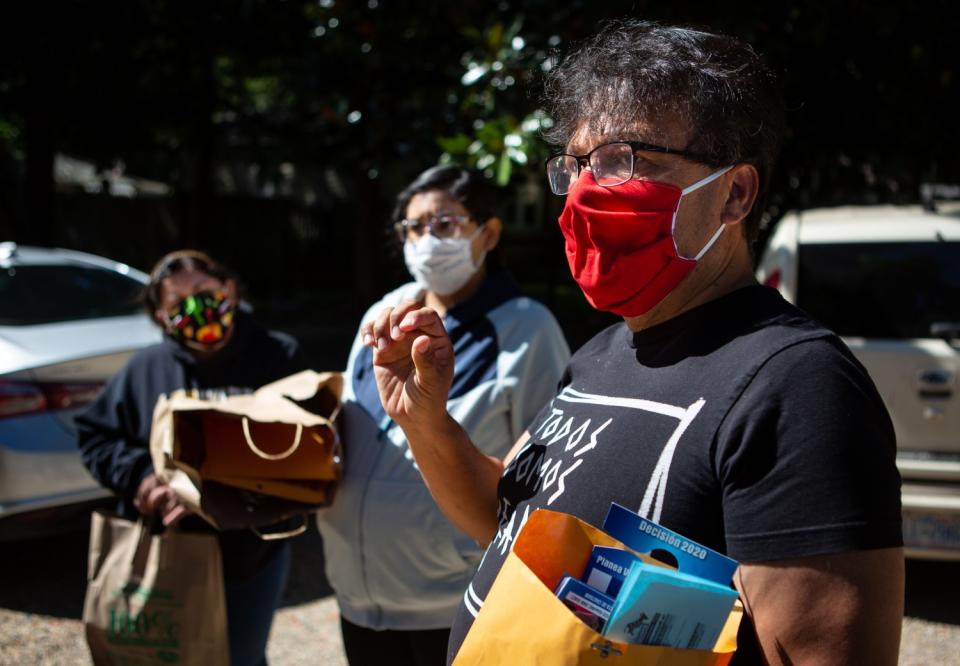 Janet Pulido, Maria Pulido and Alirio Estevez, from left, talk outside in Siler City, N.C.