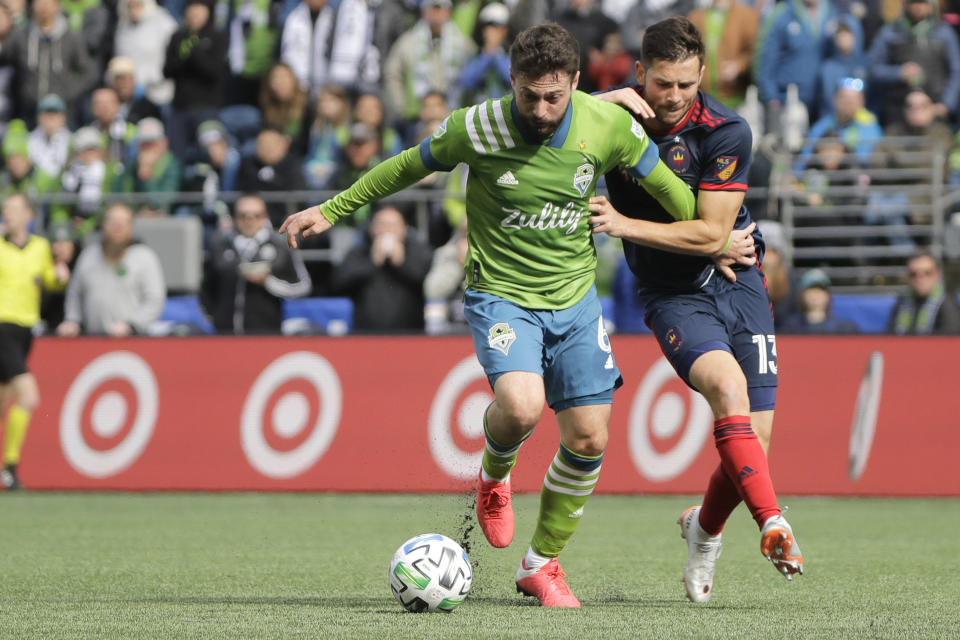 Seattle Sounders midfielder Joao Paulo, left, fends off Chicago Fire midfielder Brandt Bronico, right, during the first half of an MLS soccer match, Sunday, March 1, 2020, in Seattle. (AP Photo/Ted S. Warren)