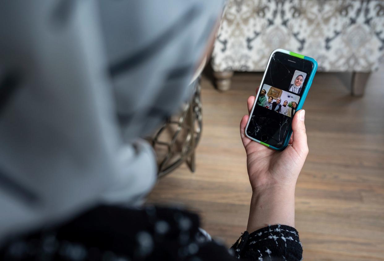 Sara Shannan, 27, a mother and University of Detroit Mercy student from Gaza, talks with her siblings through a video call inside her home in Dearborn on Wednesday, Feb. 21, 2024. Shannan's family had to flee Gaza and her siblings remain in Cairo, Egypt.