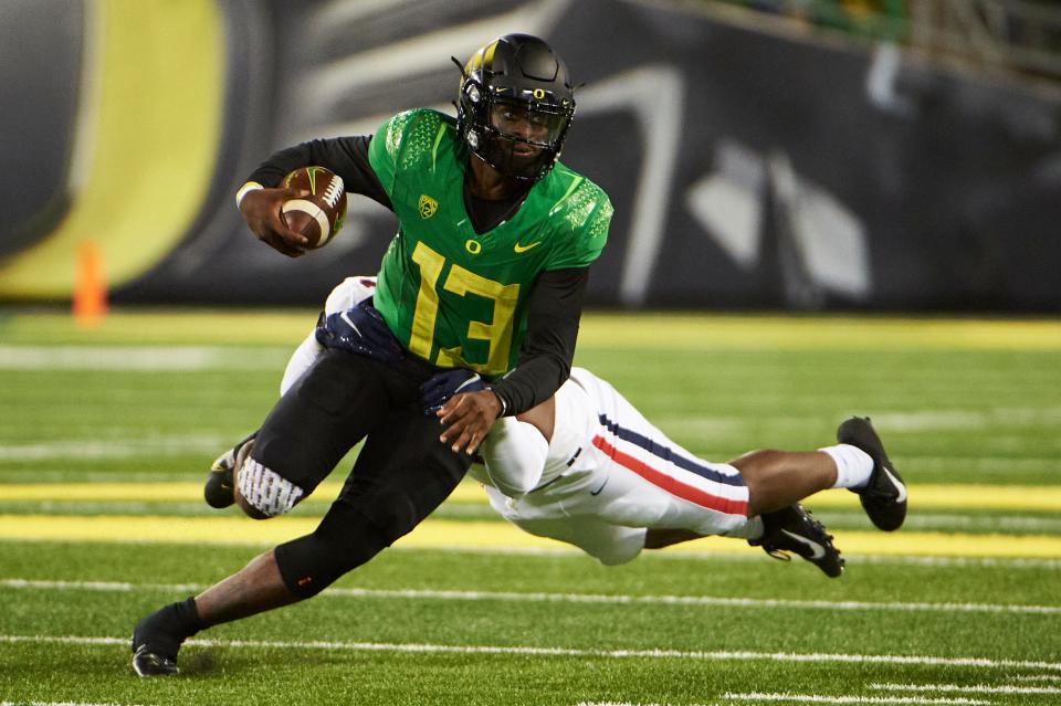 Oregon Ducks quarterback Anthony Brown (13) breaks a tackle during the second half against the Arizona Wildcats at Autzen Stadium. The Ducks won the game 41-19.