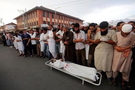 Kashmiri men offer funeral prayers for a civilian, who according to local media was killed during clashes between police and protesters, in Srinagar August 5, 2016. REUTERS/Danish Ismail