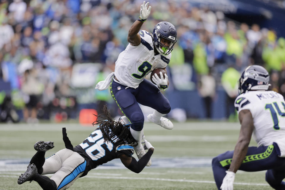 Seattle Seahawks running back Kenneth Walker III is tackled by Carolina Panthers cornerback Donte Jackson during the second half of an NFL football game Sunday, Sept. 24, 2023, in Seattle. (AP Photo/John Froschauer)