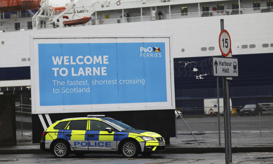 Police patrol the port of Larne, Northern Ireland, Tuesday, Feb. 2, 2021. Authorities in Northern Ireland have suspended checks on animal products and withdrawn workers from two ports after threats against border staff. (AP Photo/Peter Morrison)