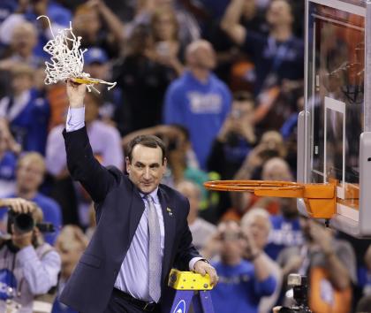 Duke head coach Mike Krzyzewski holds up the net after his team's national title game win. (AP)