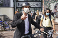 Green Party Europe-Ecologie-Les Verts (EELV) Gregory Doucet, candidate in the second round of the municipal elections, leaves the polling station on his bike after voting in Lyon, central France, Sunday, June 28, 2020. France is holding the second round of municipal elections in 5,000 towns and cities Sunday that got postponed due to the country's coronavirus outbreak. (AP Photo/Laurent Cipriani)