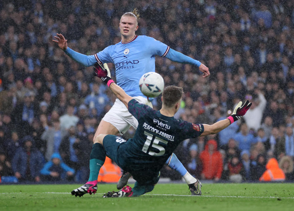 MANCHESTER, ENGLAND - MARCH 18: Erling Haaland of Manchester City scores the team's second goal past Bailey Peacock-Farrell of Burnley during the Emirates FA Cup Quarter Final match between Manchester City and Burnley at Etihad Stadium on March 18, 2023 in Manchester, England.(Photo by Clive Brunskill/Getty Images)