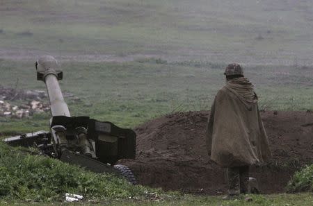 An Armenian soldier of the self-defense army of Nagorno-Karabakh stands near an artillery unit in the town of Martakert, where clashes with Azeri forces are taking place, in Nagorno-Karabakh region, which is controlled by separatist Armenians, April 3, 2016. REUTERS/Vahram Baghdasaryan/Photolure