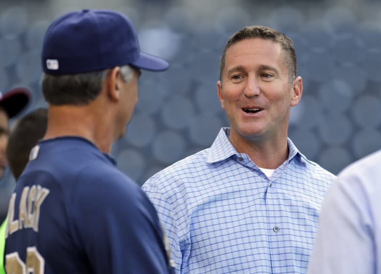 San Diego Padres general manager Josh Byrnes talks with manager Buddy Black before a baseball game against the Los Angeles Dodgers in San Diego, Wednesday, April 10, 2013. (AP Photo/Lenny Ignelzi)