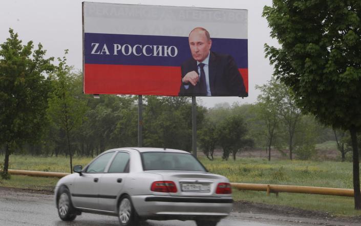 A billboard picturing Vladimir Putin in Grozny which reads 'for Russia. There is support for the Russian president in Chechnya - AP Photo/Musa Sadulayev