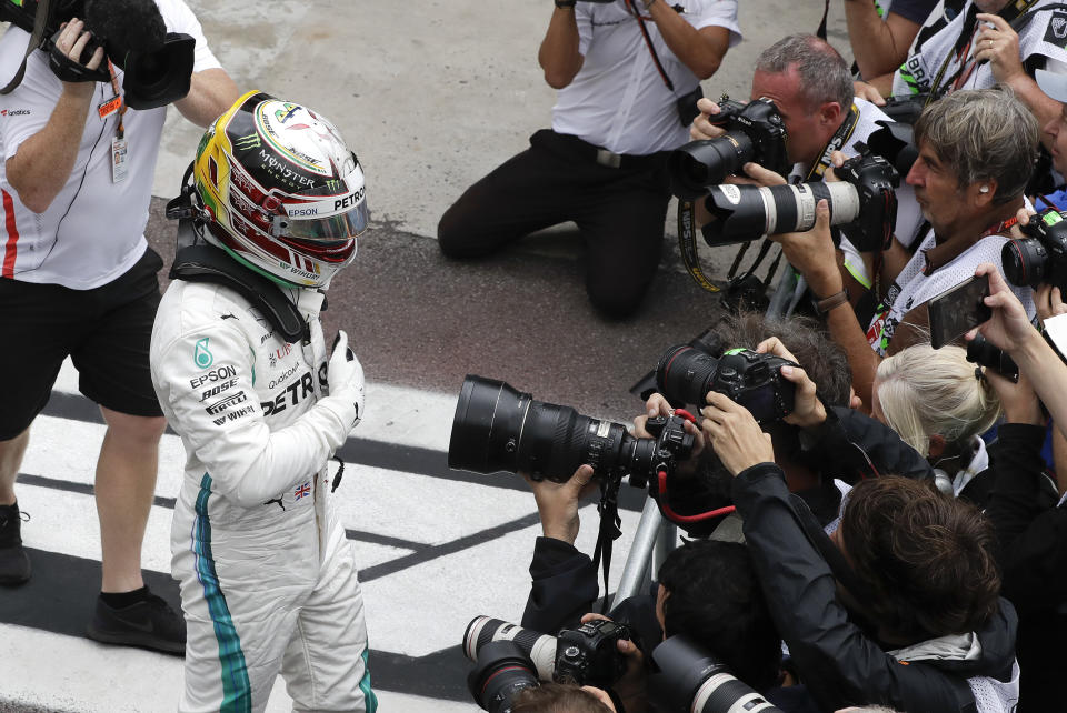 Mercedes driver Lewis Hamilton, of Britain, celebrates after he clocked the fastest time during the qualifying session for the Brazilian Formula One Grand Prix at the Interlagos race track in Sao Paulo, Brazil, Saturday, Nov. 10, 2018. (AP Photo/Andre Penner)