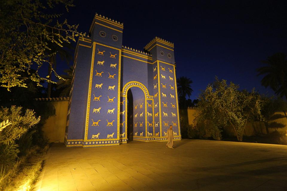 A man walks in front of Ishtar Gate the archaeological site of Babylon, Iraq, Friday, July 5, 2019. Iraq on Friday celebrated the UNESCO World Heritage Committee's decision to name the historic city of Babylon a World Heritage Site in a vote held in Azerbaijan's capital, years after Baghdad began campaigning for the site to be added to the list. (AP Photo/Anmar Khalil)