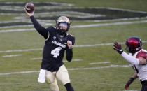 Colorado quarterback Sam Noyer, left, throws a pass as San Diego State defensive lineman Cameron Thomas pursues in the first half of an NCAA college football game Saturday, Nov. 28, 2020, in Boulder, Colo. (AP Photo/David Zalubowski)