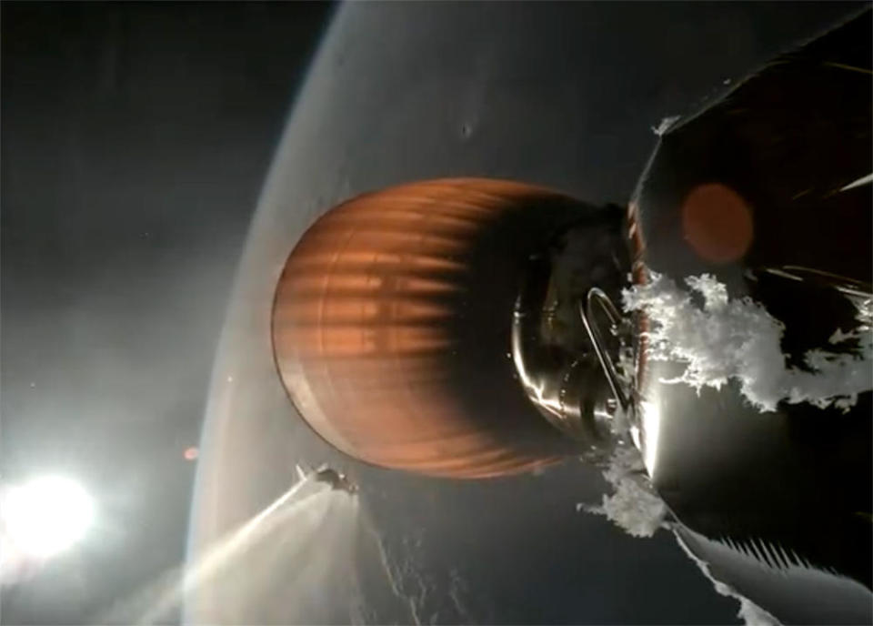 An on-board camera captured spectacular views of the Falcon 9's second stage engine during the first of two planned firings, including shots of an unusual ice buildup just above the engine at right, and a large chunk of ice falling away at left that is seen at the moment the heat of the engine begins vaporizing it. The engine apparently exploded, or came apart in some fashion, during a second planned burn. / Credit: SpaceX