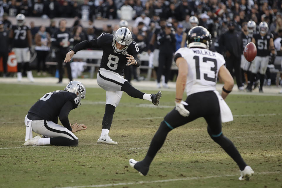 Oakland Raiders kicker Daniel Carlson misses the first of two field goal attempts late in the second half of an NFL football game against the Jacksonville Jaguars in Oakland, Calif., Sunday, Dec. 15, 2019. Jacksonville won the game 20-16. Holding the ball was the Raiders' A.J. Cole and at right is Jacksonville Jaguars wide receiver Michael Walker (13). (AP Photo/Ben Margot)