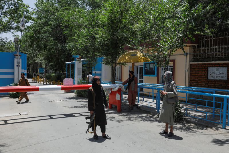 Taliban soldiers are seen at a checkpoint at the entrance of Kabul University in Kabul