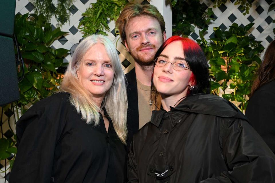 <p>Michael Kovac/Getty Images for Support + Feed</p> Maggie Baird, Finneas, Billie Eilish in Los Angeles on Oct. 24, 2023.