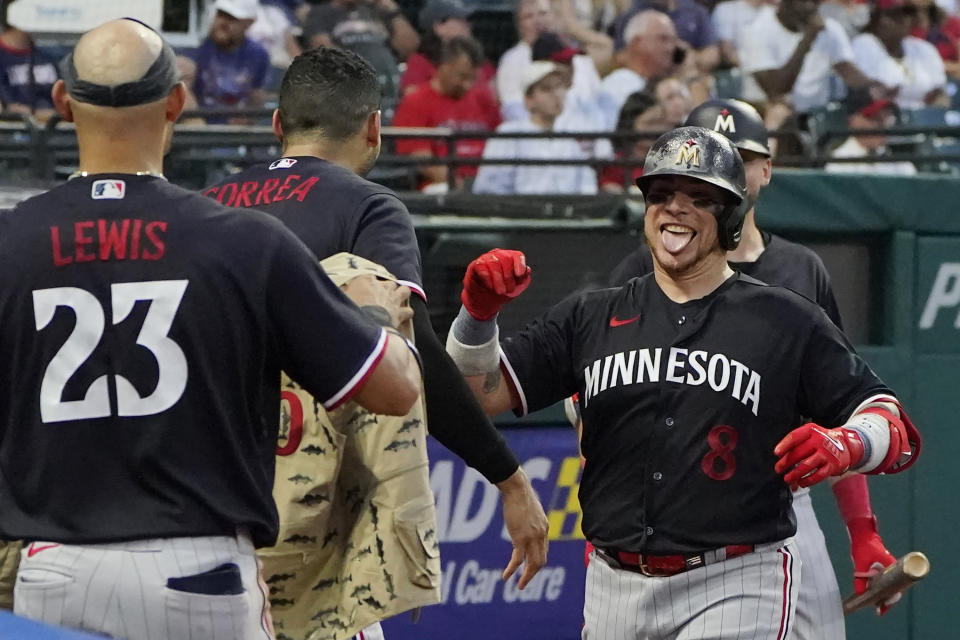 Minnesota Twins' Christian Vázquez (8) celebrates with Carlos Correa, center, and Royce Lewis (23) following his home run in the sixth inning of a baseball game against the Cleveland Guardians, Tuesday, Sept. 5, 2023, in Cleveland. (AP Photo/Sue Ogrocki)