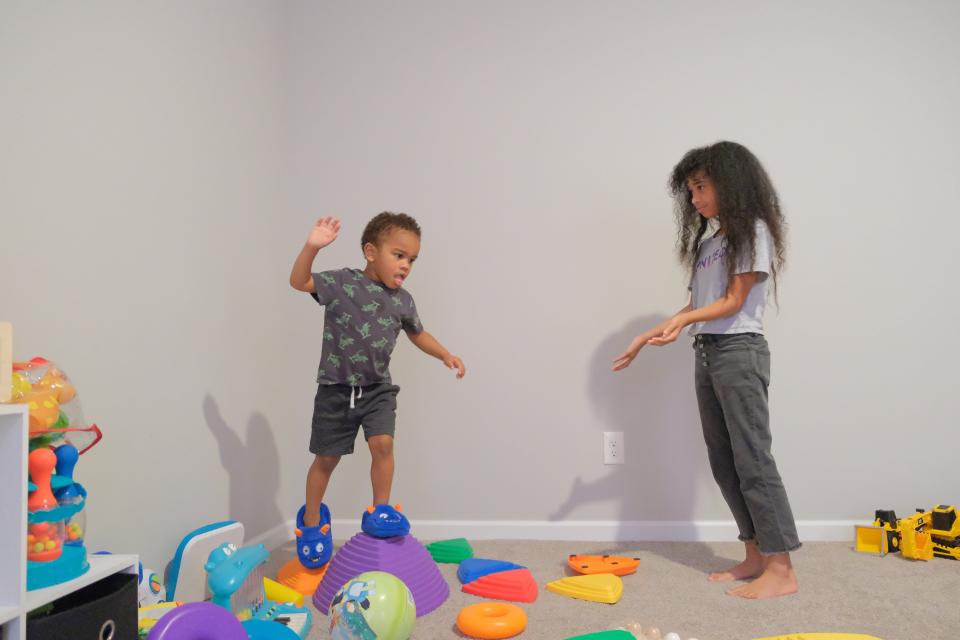 Zaire “Rico” McCurdy, 3, and his older sister, Amilliana McCurdy, 10, play in their Pataskala home. Rico is on the autism spectrum and his playroom is filled with sensory toys.