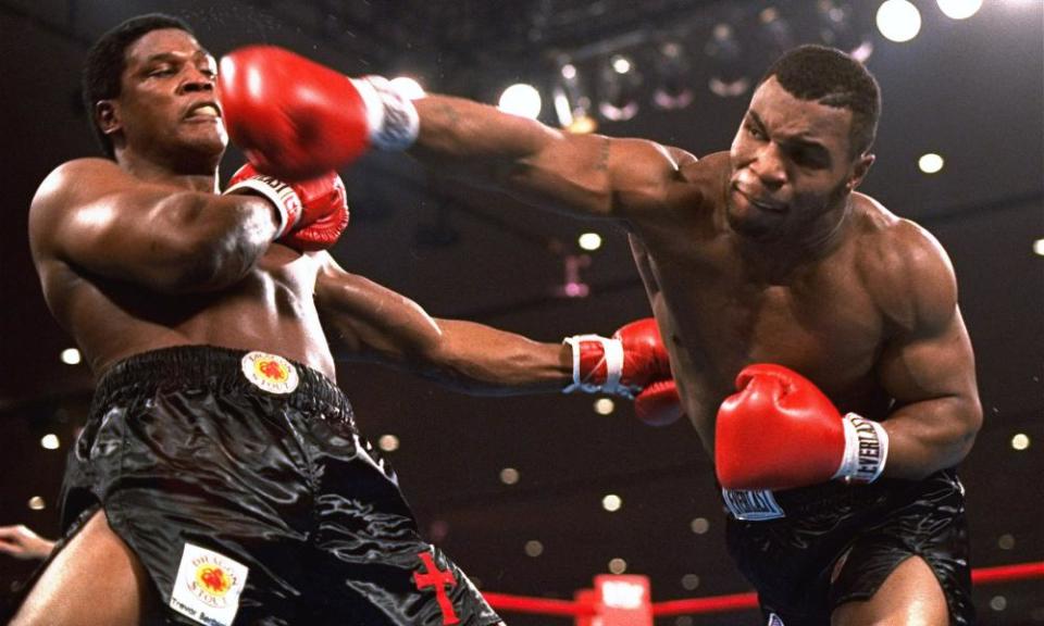 Mike Tyson delivers a right hand to Trevor Berbick in 1986.