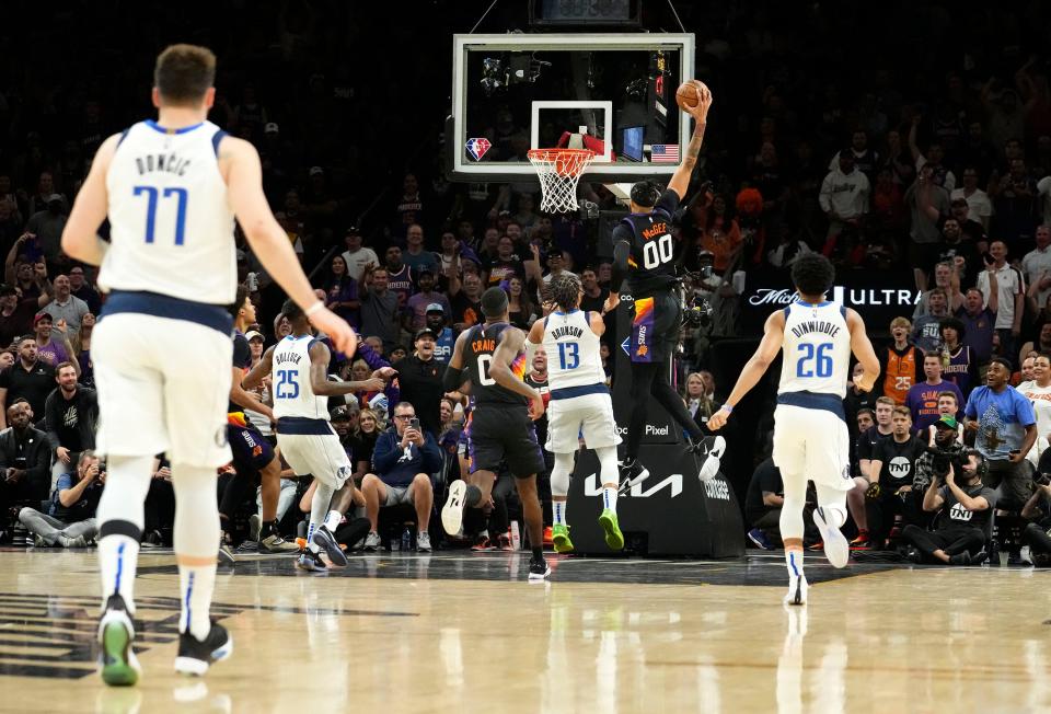 May 2, 2022; Phoenix, Arizona, USA; Phoenix Suns center JaVale McGee (00) slam-dunks the ball after stealing it from Dallas Mavericks guard Luka Doncic (77) during game one of the second round for the 2022 NBA playoffs at Footprint Center.