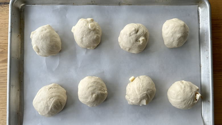 Balls of bagel dough on baking sheet