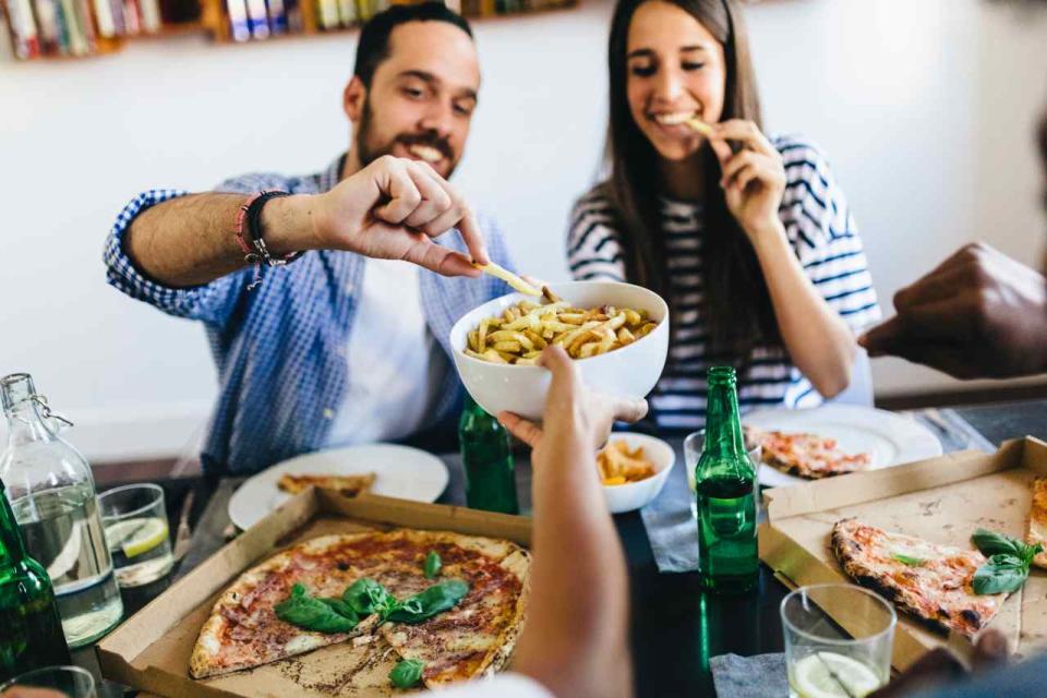 Group of friends having a pizza at home