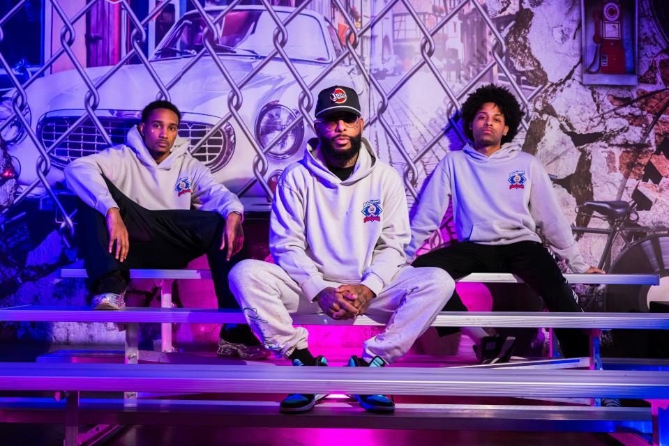 Items from the new "Detroit Pistons x J Dilla" apparel collection are pictured worn by (from left) rapper Nassan, son of the late Proof; rapper Royce 5'9"; and Daniel Hex, a rapper and son of Royce.