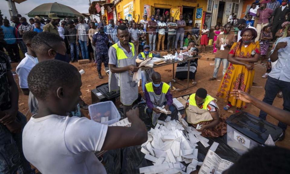 Election officials count the ballots after polls closed in Kampala on Thursday