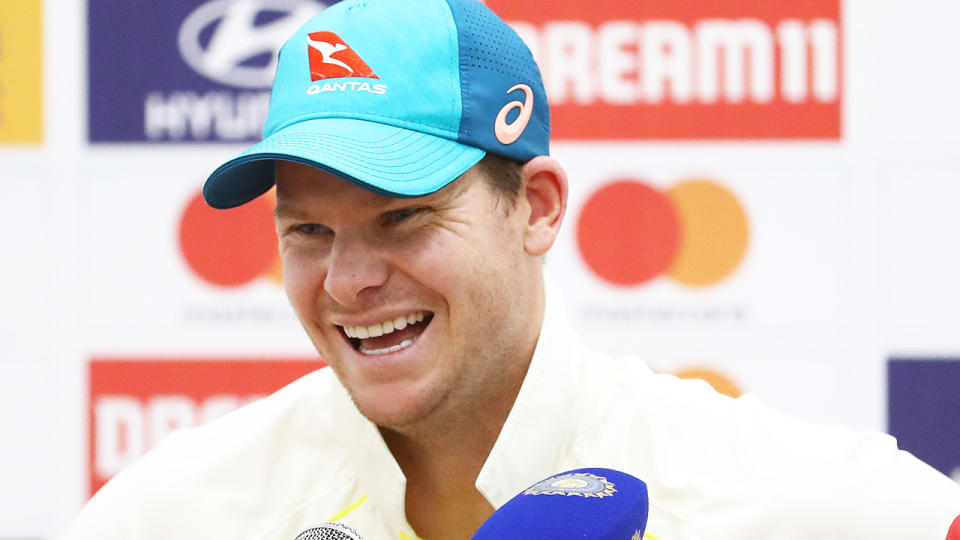 Steve Smith laughs with reporters at a press conference.