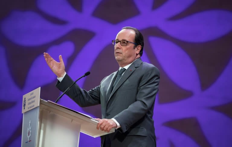 French President Francois Hollande delivers a speech after visiting an exhibition and unveiling a commemorative stamp celebrating the 100th anniversary of the birth of the late French president Francois Mitterand