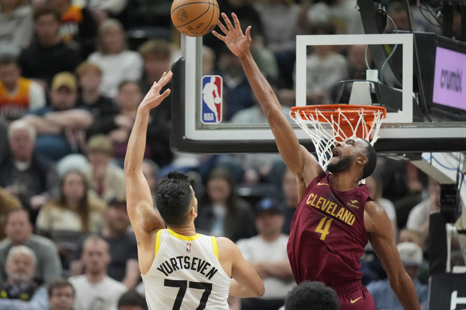 Cleveland Cavaliers forward Evan Mobley (4) blocks the shot from Utah Jazz center Omer Yurtseven (77) during the first half of an NBA basketball game Tuesday, April 2, 2024, in Salt Lake City. (AP Photo/Rick Bowmer)