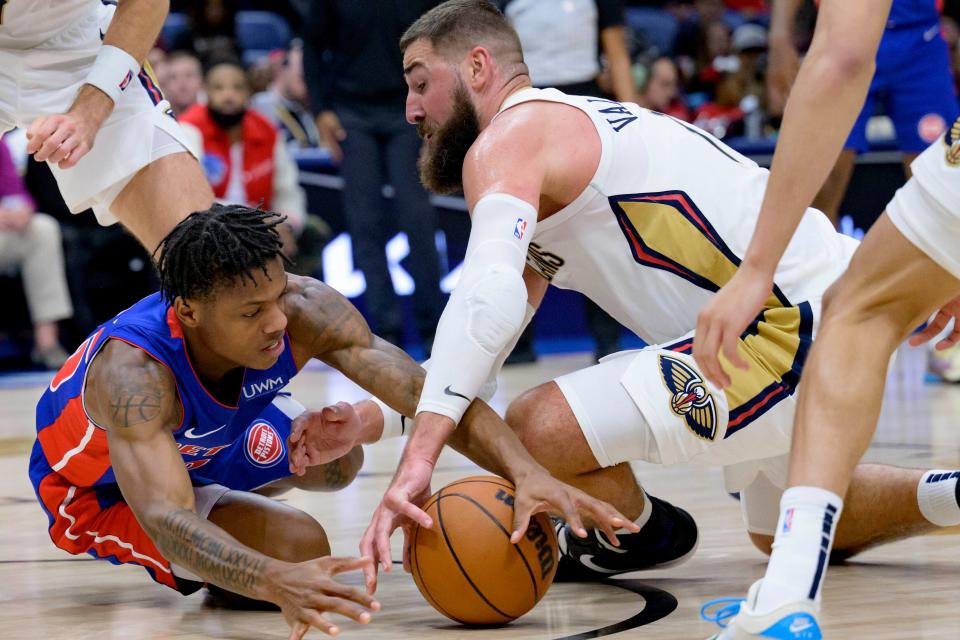 Detroit Pistons guard Marcus Sasser, left, and New Orleans Pelicans center Jonas Valanciunas scramble for the ball during the first half at Smoothie King Center in New Orleans on Thursday, Nov. 2, 2023.