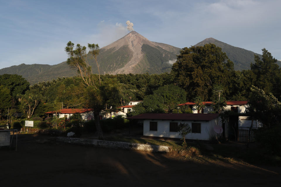 The Volcan de Fuego, or Volcano of Fire, spews a plume of ash as seen from San Juan Alotenango, Guatemala, Tuesday, Nov. 20, 2018. The volcanology institute reported that activity subsided Monday evening. Hundreds of families who heeded the call of disaster coordination authorities to evacuate 10 communities began returning to their homes Tuesday. (AP Photo/Moises Castillo)