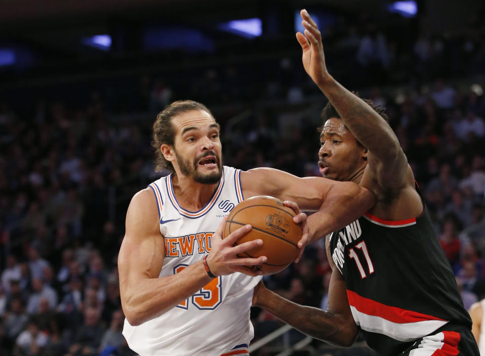 FILE - In this Nov. 27, 2017, file photo, New York Knicks center Joakim Noah (13), making his season debut after a suspension for performance enhancing drugs, goes up against Portland Trail Blazers forward Ed Davis (17) during the first half of an NBA basketball game in New York. Noah’s disappointing Knicks career is over after just two seasons. Unable to find a trade, the Knicks waived the center Saturday, Oct. 13, 2018, with two years and $37.8 million remaining on his contract. (AP Photo/Kathy Willens, File)