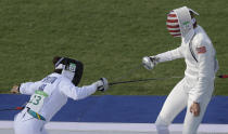 FILE - In this Aug. 19, 2016, file photo, gold medal winner Chloe Esposito of Australia, left, competes against Isabella Isaksen of the United States in the fencing portion of the women's modern pentathlon at the Summer Olympics in Rio de Janeiro, Brazil. Esposito announced in late January that a “wonderful, unexpected surprise” had occurred and that the Australian wouldn’t be able to defend her modern pentathlon gold medal at the Tokyo Olympics. She was pregnant with her first child. Two months later Esposito and thousands of other Olympic athletes learned that the Tokyo Games would be put off by a year until July 2021 because of the coronavirus pandemic. While for some it meant more time to recover from injuries or extra time to prepare, Esposito realized it might give her a second chance to be in Tokyo next year. (AP Photo/Kirsty Wigglesworth, File)