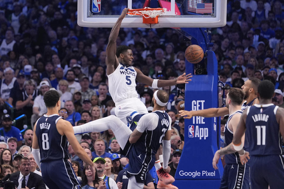 Minnesota Timberwolves guard Anthony Edwards (5) scores over Dallas Mavericks center Daniel Gafford (21) during the second half in Game 3 of the NBA basketball Western Conference finals, Sunday, May 26, 2024, in Dallas. (AP Photo/Julio Cortez)